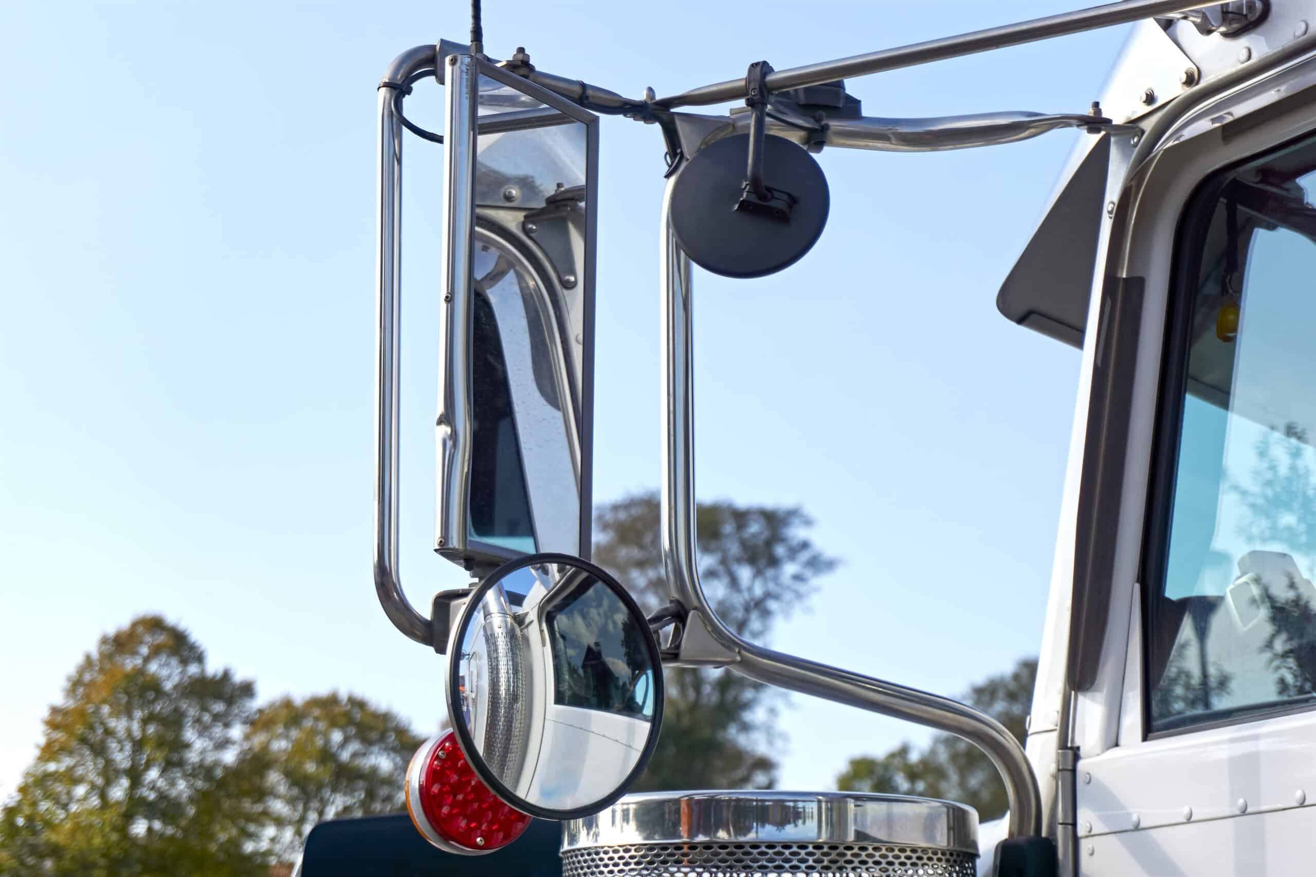 the side-view mirrors of a large tractor-trailer. 